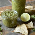 Salsa Verde with chips a lime and cilantro garnish