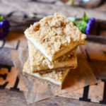 Cheesecake Cookies on a parchment square with a deep purple flower in the background