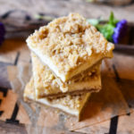 Cheesecake Cookies on a parchment square with a deep purple flower in the background