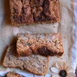 Sliced pear almond bread with a flower beside.