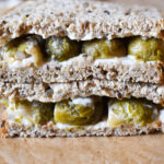 A brussel sprout sandwich on a cutting board