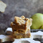 Spiced Pear Crumb Bars on a big wooden snowflake, then on a cookie rack with pears in the background