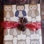 Owl gift wrap, a pinecone decorations, and thick red polka dot ribbon