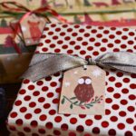 Holiday red polka dot gift wrap, an owl tag, and tick brown ribbon