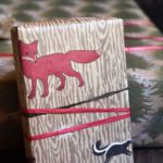 A woodsy wrapping paper with a red fox and skunk on the front