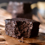 A Flourless Cocoa Brownie with a bite taken out and others in the background.