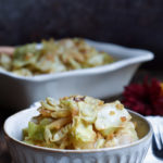 A bowl of Momma's Best Soy Ginger Cabbage with a filled serving dish in the background.