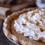 A close up of Butterscotch Pie with Spiced Rum Whipped Cream