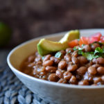 Instant Pot Pinto Beans topped with avocado, diced tomato, and cilantro