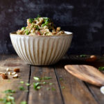 Cilantro and crushed almonds leading to a bowl of Lemon Vegetable Quinoa Salad