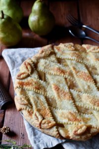Perfect Spice Pear Pie with pears and silverware in the background