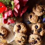 An overview of Blueberry Coconut Clove Scones with blueberries and red and blue flowers