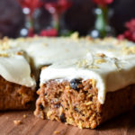 A side slice of Bourbon Orange Spiced Carrot Cake with more in the background