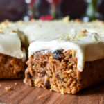 A side slice of Bourbon Orange Spiced Carrot Cake with more in the background