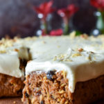 A side slice of Bourbon Orange Spiced Carrot Cake with more in the background