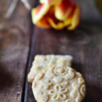 Flower Embossed Lemon Sugar Cookies with a tulip in the background