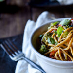 Easy Udon Noodle Vegetable Stir Fry on a napkin with a for beside.