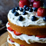 Three layers of fluffed almond and spice cake, whipped cream cheese and colorful fruit.