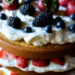 Three layers of fluffed almond and spice cake, whipped cream cheese and colorful fruit.
