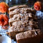 Cinnamon Orange Raisin Bread cut and staggered with orange flowers on each side.