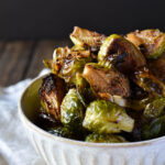 A bowl of Roasted Garlic Balsamic Brussel Sprouts on a napkin.