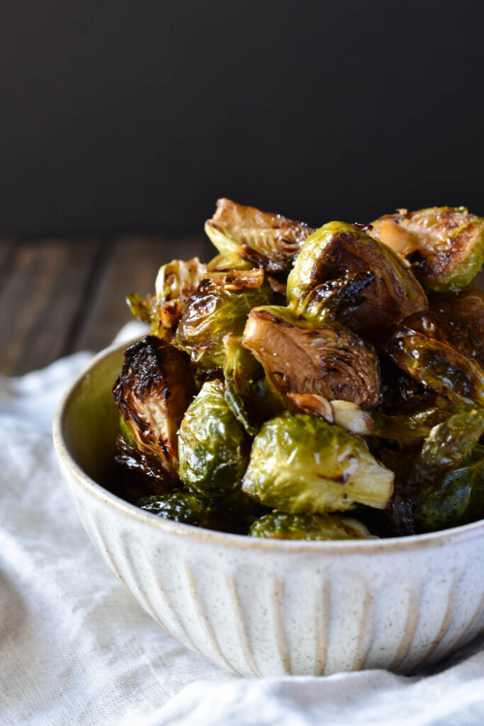 A bowl of Roasted Garlic Balsamic Brussel Sprouts on a napkin.