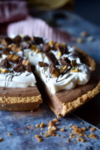 Frozen Chocolate Peanut Butter Pie with a slice being taken out.