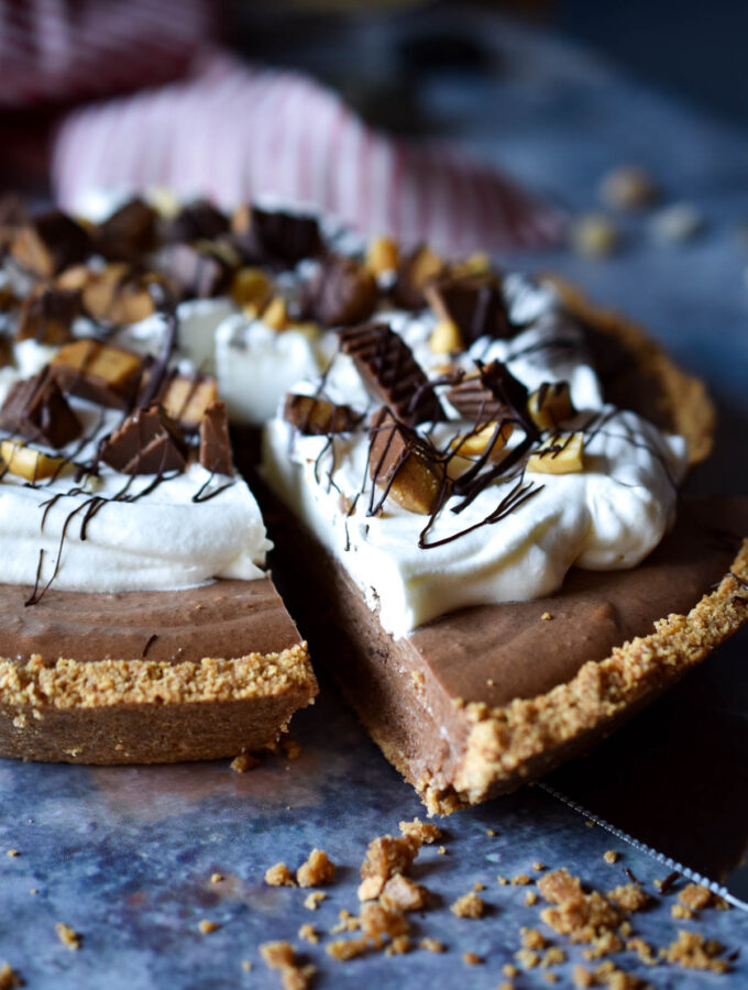 Frozen Chocolate Peanut Butter Pie with a slice being taken out.