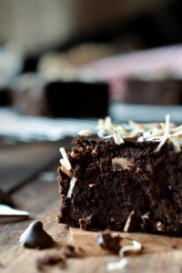 A close up of a Chocolate Cherry Coconut Brownie with others in the background.